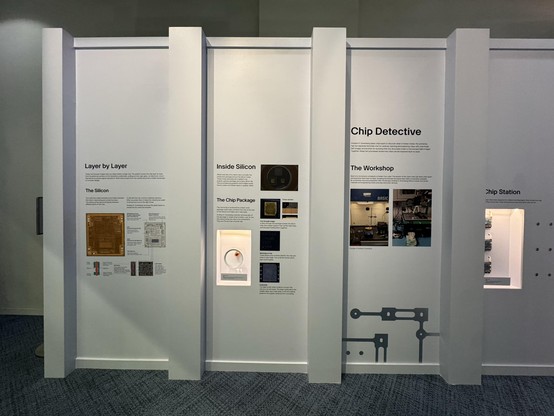 Closer view of the exhibit showing a decapped PIC12F683 zooming in to a single inverter, a cross sectioned package, and some photos of my lab setup