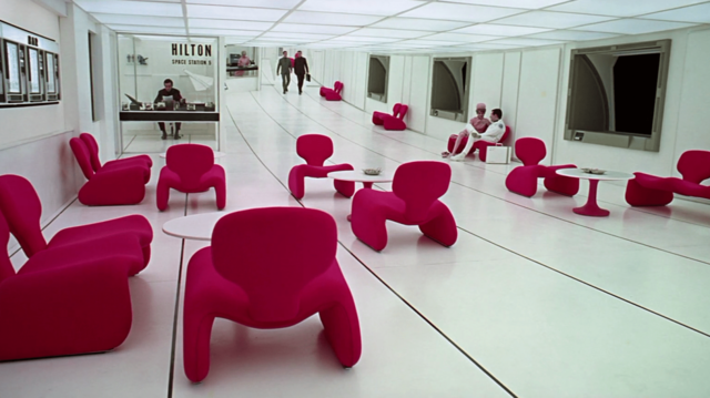The lounge from 2001: A Space Odyssey. Stark white with red furniture and regular windows peering out into pitch black space