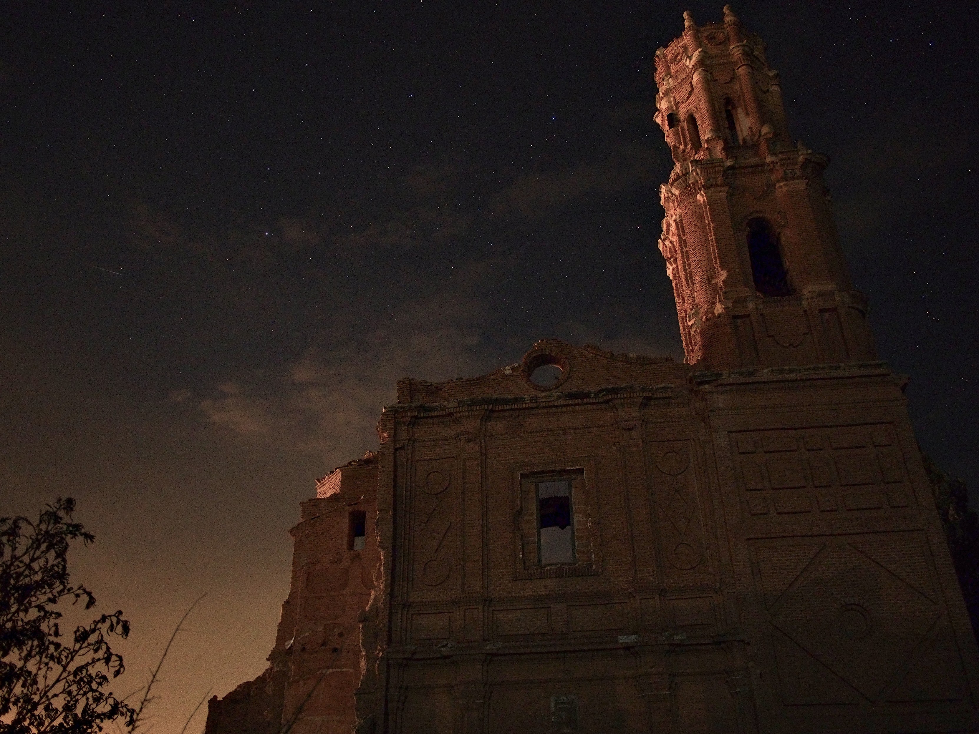 The ominous ruins of an old church against a starry sky.